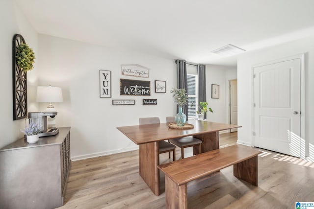 dining area with light hardwood / wood-style flooring