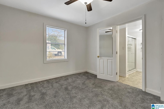 carpeted spare room featuring ceiling fan