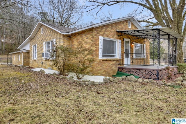 view of home's exterior with cooling unit and a porch