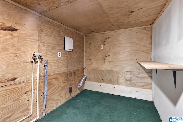 interior space with wooden ceiling, carpet flooring, and wood walls