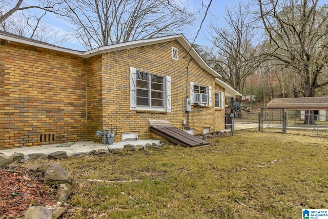 view of home's exterior with cooling unit and a lawn