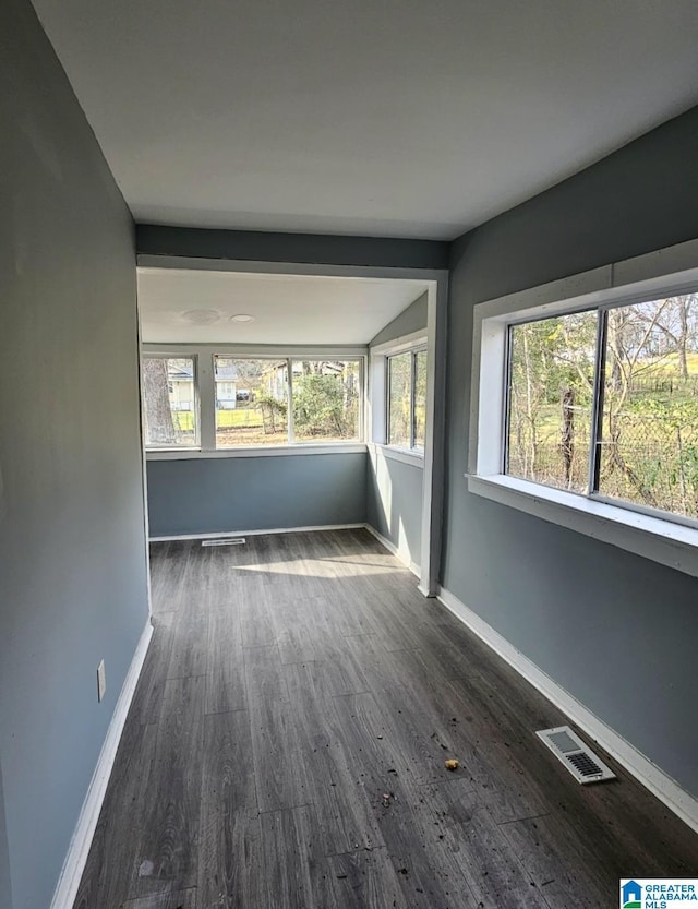 empty room with lofted ceiling and dark hardwood / wood-style flooring