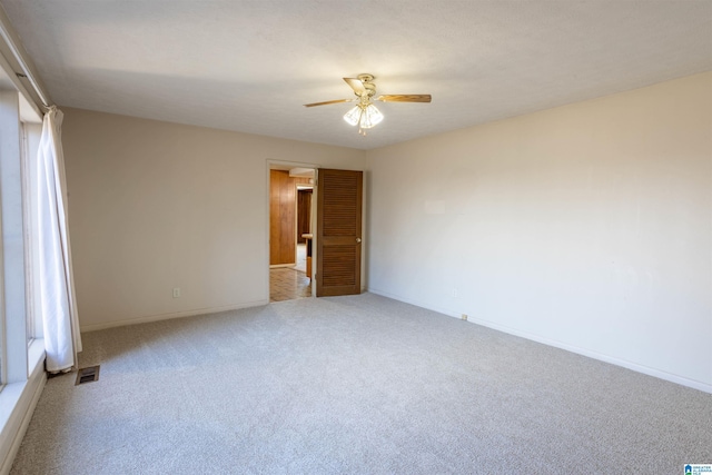 unfurnished bedroom featuring ceiling fan and light carpet