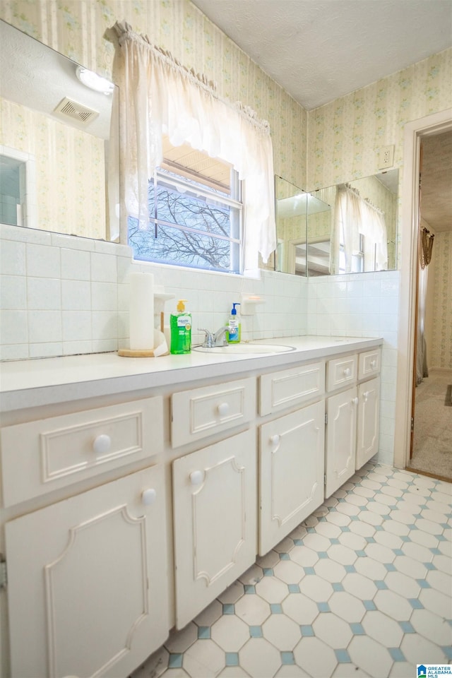 bathroom featuring vanity and backsplash