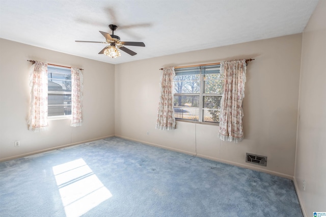 carpeted spare room with ceiling fan