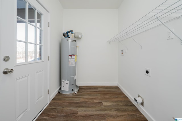 clothes washing area featuring electric dryer hookup, dark wood-type flooring, and electric water heater