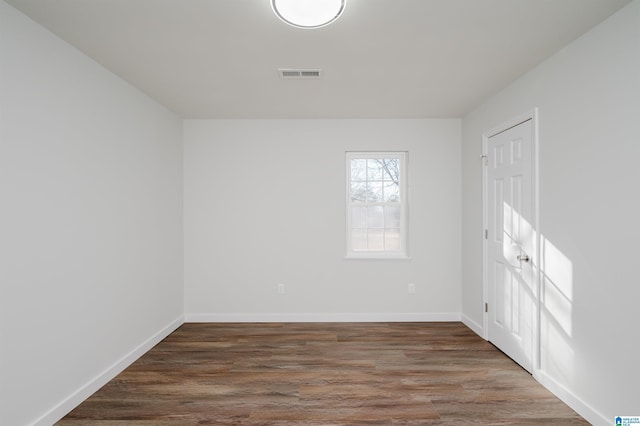 unfurnished room featuring dark hardwood / wood-style flooring