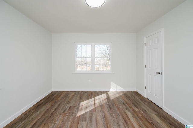 spare room with dark hardwood / wood-style flooring