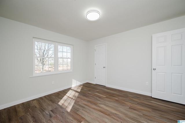 empty room with dark wood-type flooring