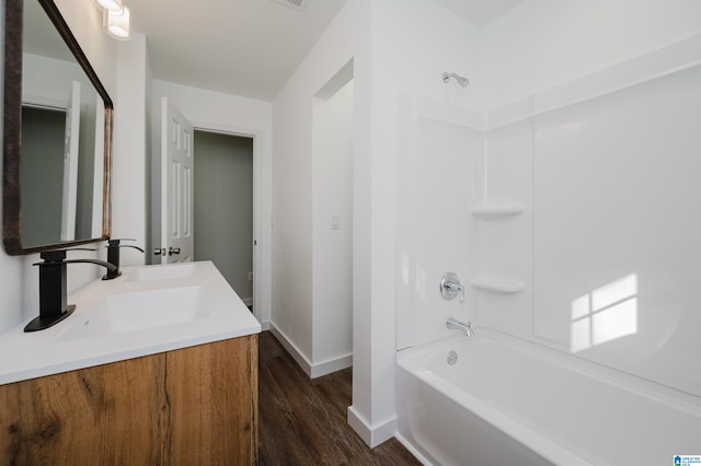 bathroom with tub / shower combination, wood-type flooring, and vanity