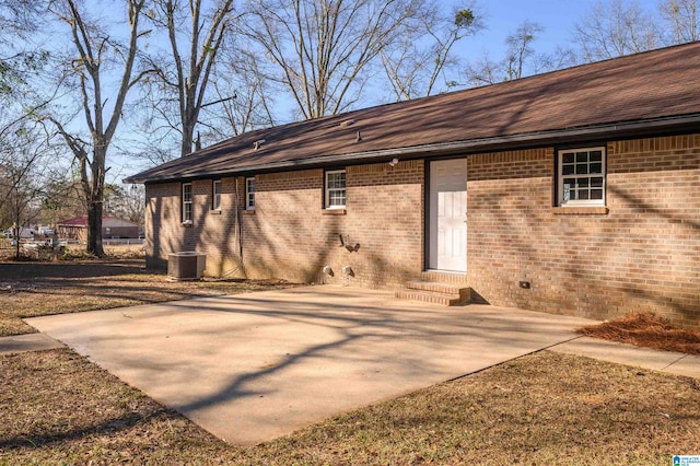 rear view of house with central air condition unit and a patio area