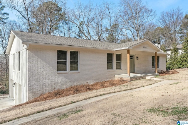 single story home featuring a porch and a garage