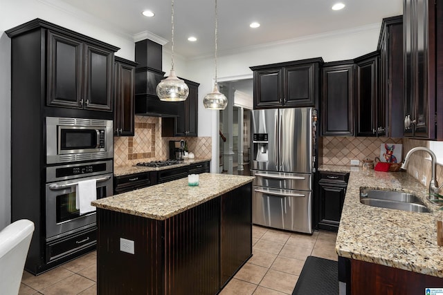 kitchen featuring hanging light fixtures, sink, light tile patterned floors, a center island, and stainless steel appliances