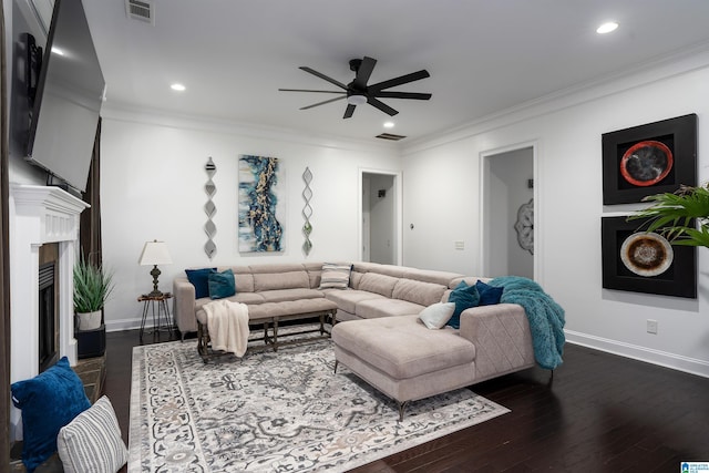 living room with ceiling fan, ornamental molding, and dark hardwood / wood-style flooring