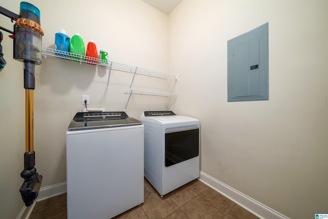 washroom featuring washer and dryer, electric panel, and tile patterned flooring