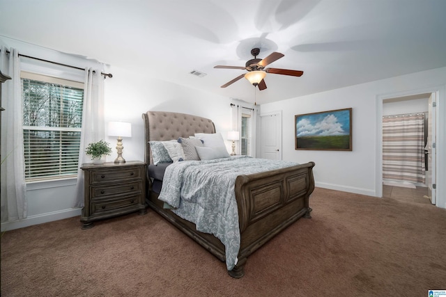 bedroom with ceiling fan and dark colored carpet