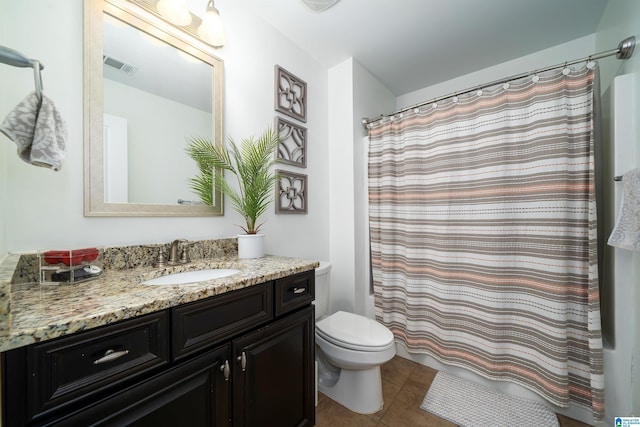 bathroom featuring curtained shower, tile patterned floors, vanity, and toilet