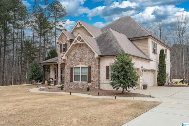 craftsman house with a garage and a front lawn