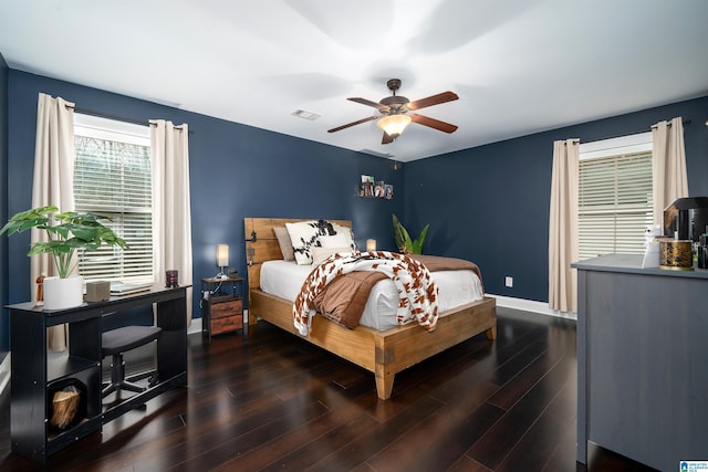 bedroom with ceiling fan and dark hardwood / wood-style floors