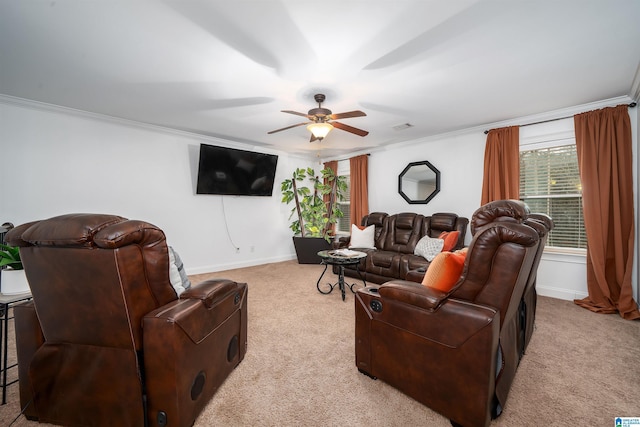 carpeted living room with ceiling fan and ornamental molding