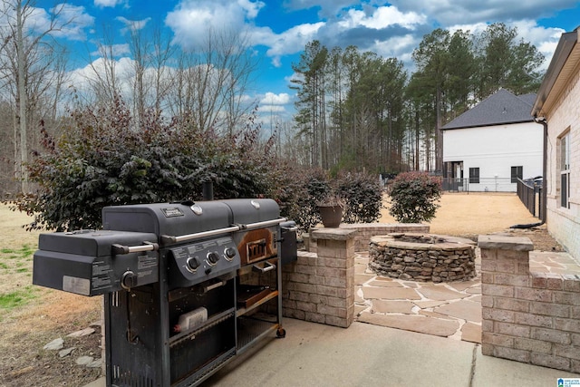 view of patio with an outdoor fire pit and area for grilling