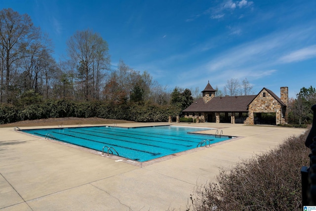 view of swimming pool with a patio area