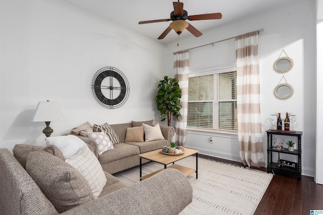 living room featuring ceiling fan and dark hardwood / wood-style flooring