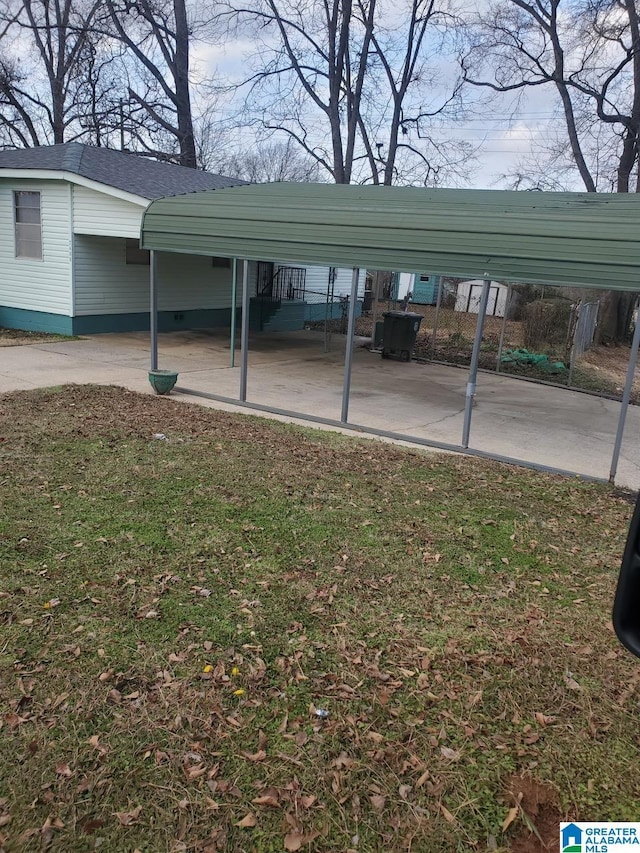 view of parking featuring a lawn and a carport