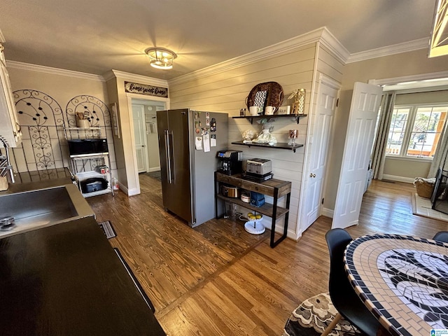 kitchen featuring sink, stainless steel fridge, dark hardwood / wood-style floors, and crown molding