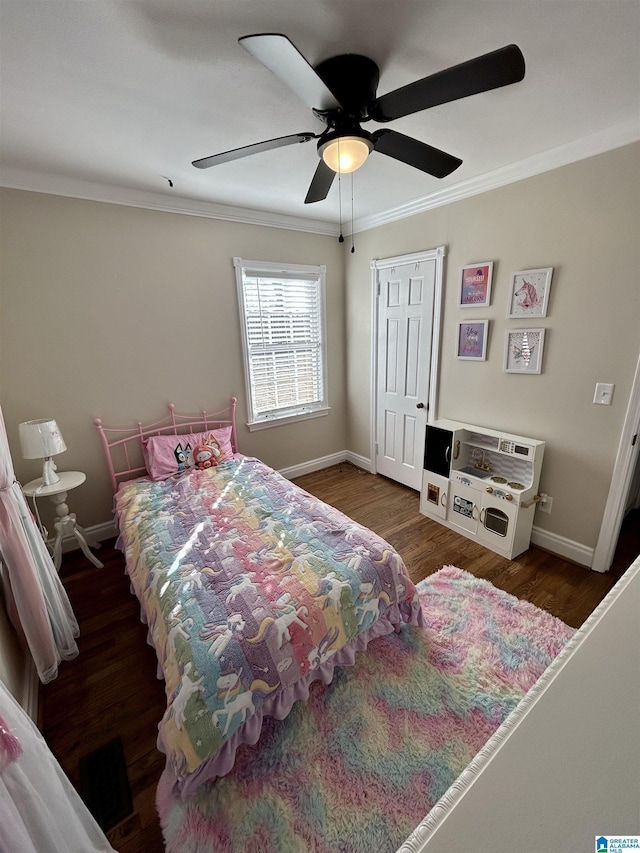 bedroom with ceiling fan, dark wood-type flooring, and crown molding