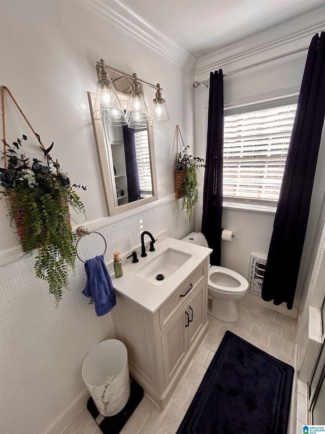 bathroom featuring toilet, vanity, tile patterned flooring, tile walls, and ornamental molding