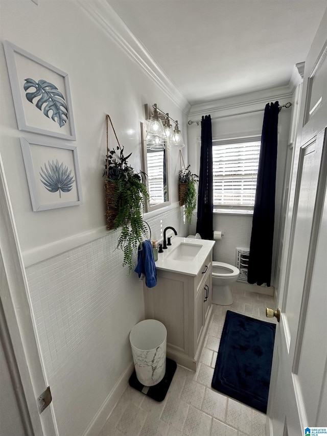 bathroom featuring toilet, vanity, tile patterned flooring, crown molding, and heating unit