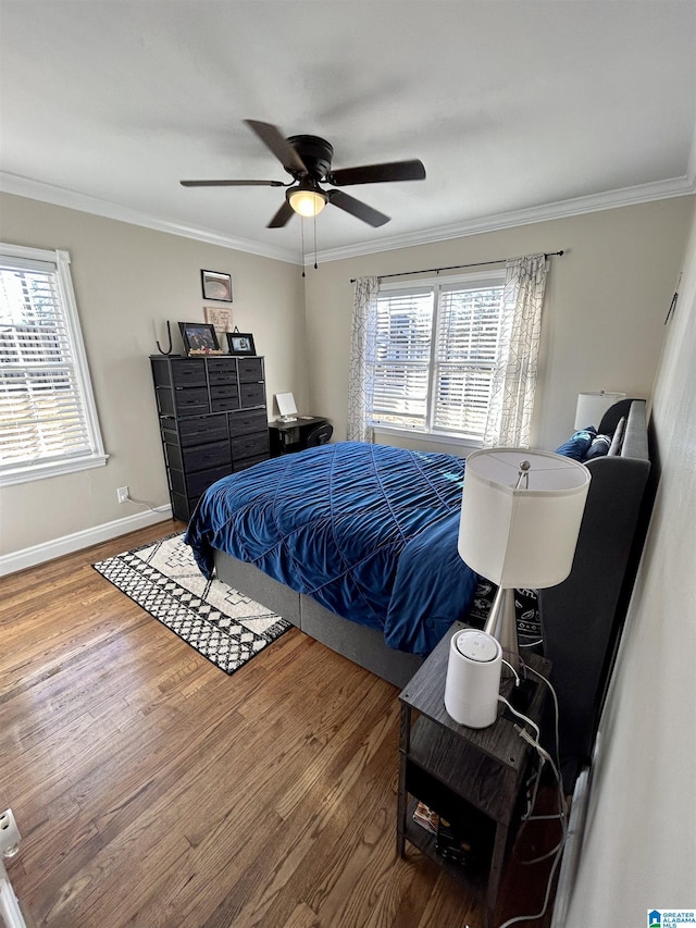 bedroom featuring ceiling fan, hardwood / wood-style flooring, and crown molding