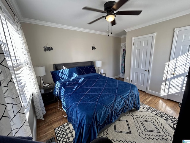 bedroom featuring ceiling fan, crown molding, and dark hardwood / wood-style floors