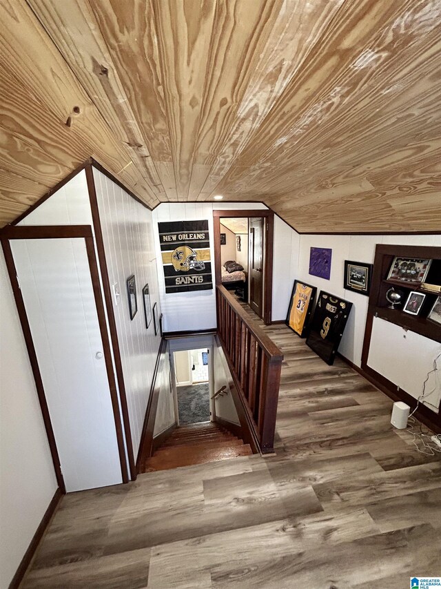 additional living space with wood ceiling and hardwood / wood-style flooring