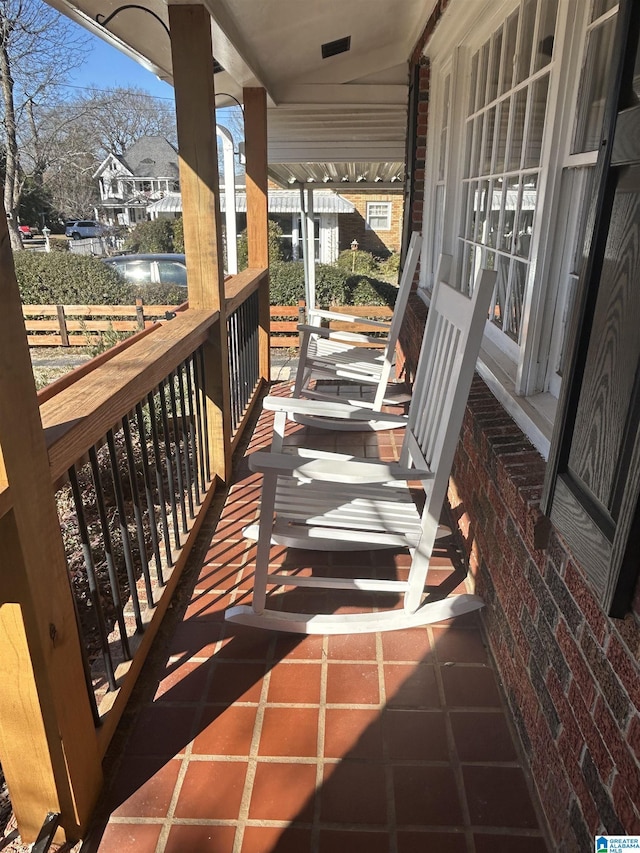 view of patio with a water view and covered porch