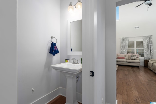 bathroom featuring ceiling fan, wood-type flooring, and sink