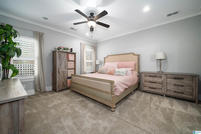 bedroom featuring ceiling fan, crown molding, and light colored carpet