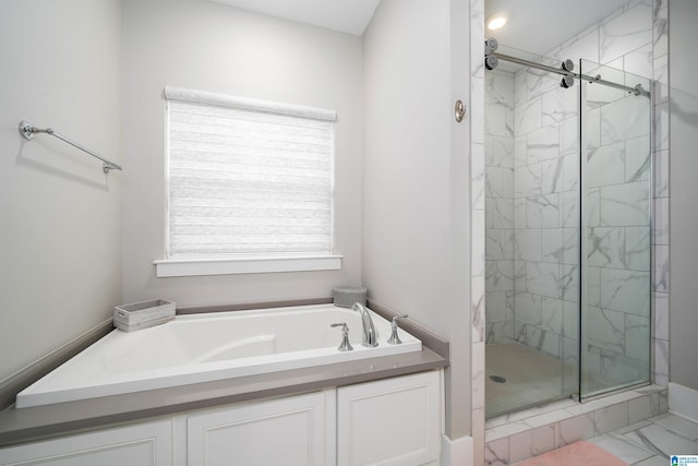 bathroom with separate shower and tub