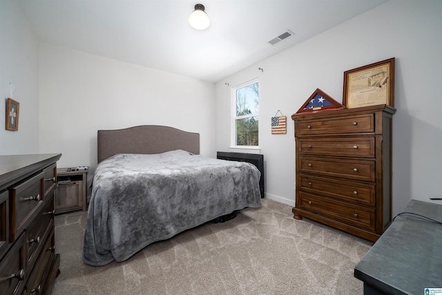 bedroom featuring light colored carpet