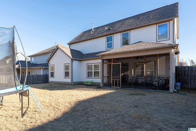 back of property with a trampoline and a sunroom