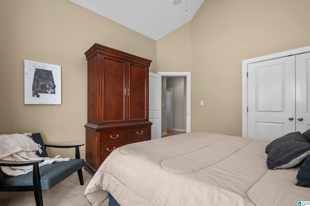 bedroom featuring ceiling fan, high vaulted ceiling, carpet floors, and a closet