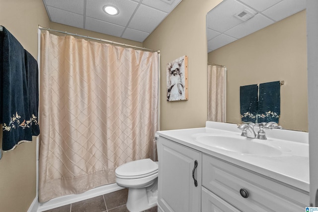 bathroom featuring vanity, a drop ceiling, a shower with curtain, tile patterned floors, and toilet