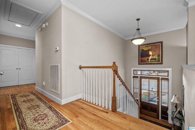 foyer featuring crown molding and hardwood / wood-style floors