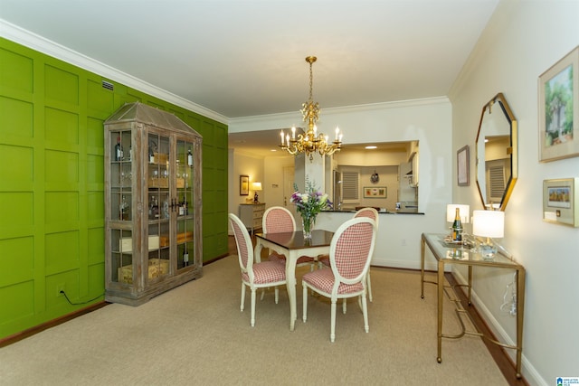 dining room featuring a notable chandelier, light colored carpet, and ornamental molding