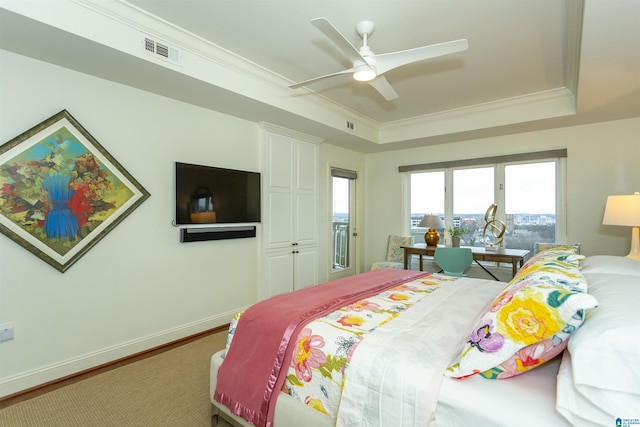 bedroom with ceiling fan, a raised ceiling, crown molding, and wood-type flooring