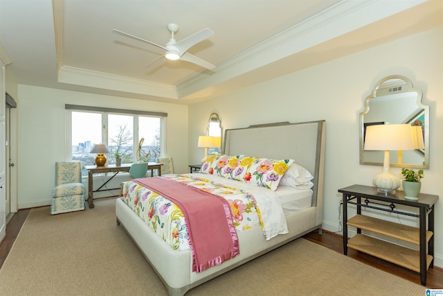 bedroom featuring ceiling fan and a tray ceiling