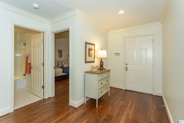 entryway with dark hardwood / wood-style flooring and crown molding