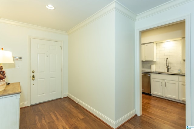 interior space featuring sink, ornamental molding, and dark wood-type flooring