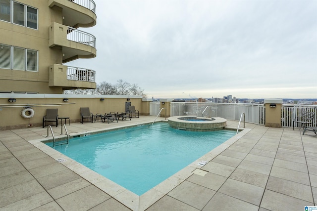 view of pool featuring a patio and a hot tub